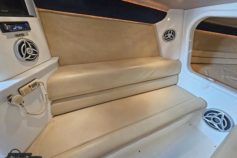 Slide: The Image of Interior of 2007 Hustler 41 Razor boat with beige seating and audio system. - 82