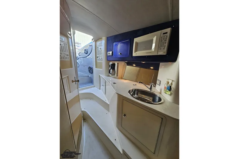 Slide: The Image of 2007 Hustler 41 Razor boat interior with kitchenette, sink, and microwave. - 85
