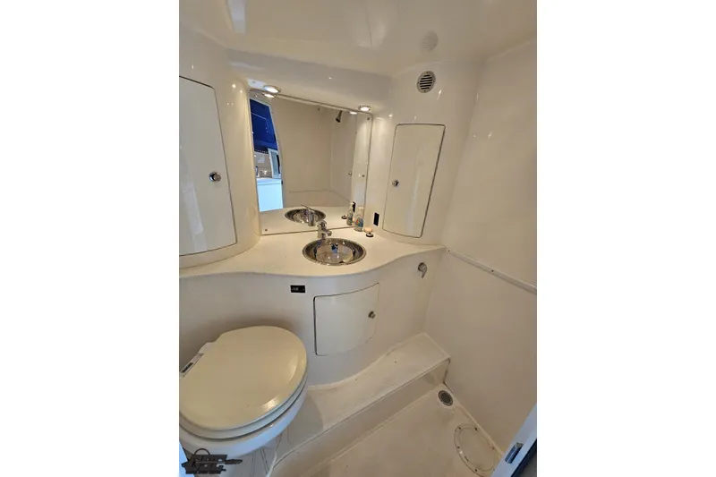 Slide: The Image of 2007 Hustler 41 Razor boat bathroom with sink, toilet, and storage cabinets. - 91