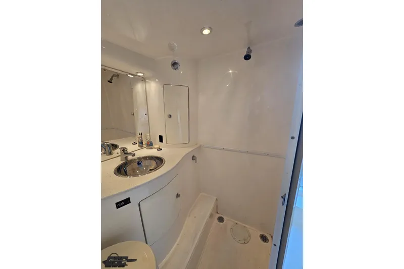 Slide: The Image of 2007 Hustler 41 Razor boat bathroom with sink, mirror, and shower area. - 92