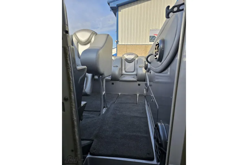 Slide: The Image of Interior view of 2007 Hustler 41 Razor boat with gray seating and carpeted flooring. - 93