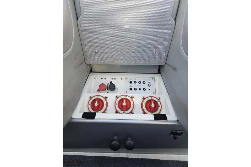 Slide: The Image of Control panel of a 2007 Hustler 41 Razor boat with switches and dials. - 98