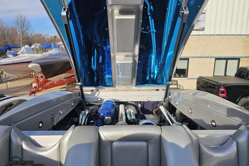 Slide: The Image of 2007 Hustler 41 Razor boat engine compartment with open hatch, showcasing powerful engines. - 99