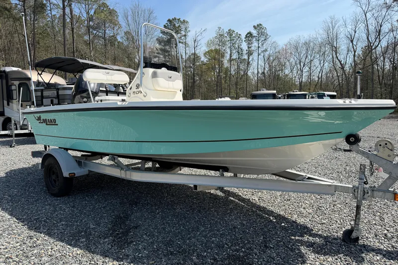 Slide: The Image of 2018 Mako 19 CPX boat on trailer, parked outdoors on gravel lot. - 18