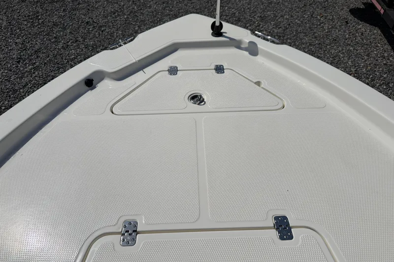 Slide: The Image of 2018 Mako 19 CPX boat deck with storage compartments and textured surface. - 21