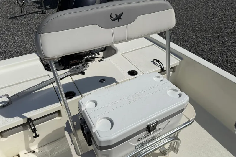 Slide: The Image of 2018 Mako 19 CPX boat interior with cooler and seating arrangement. - 28