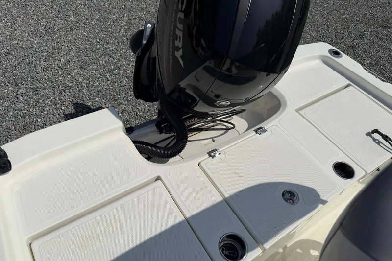 Slide: The Image of 2018 Mako 19 CPX boat with Mercury outboard motor on gravel surface. - 29