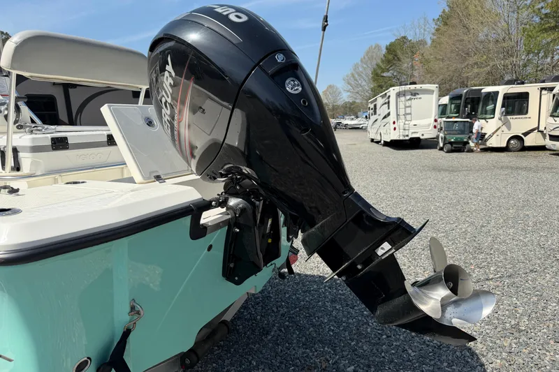 Slide: The Image of 2018 Mako 19 CPX boat with Mercury outboard motor in a parking area. - 33