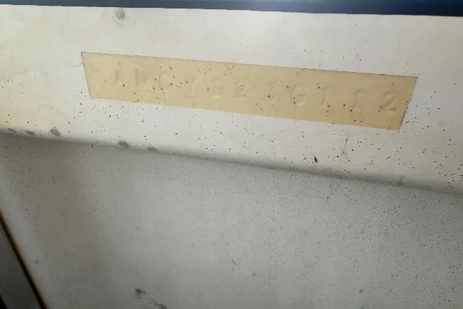 Slide: The Image of 2012 Yamaha Boats SX210 hull identification number on a boat surface. - 15