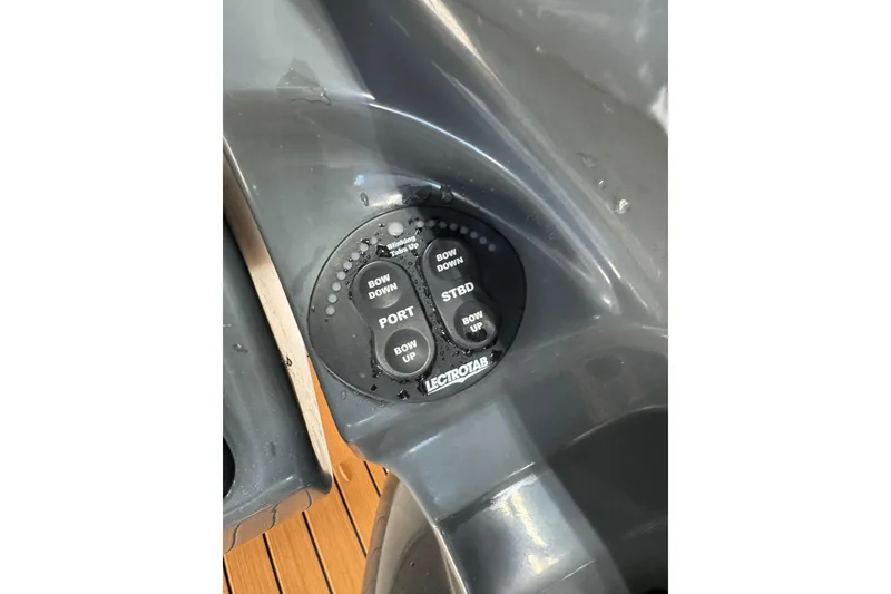 Slide: The Image of Control panel of a 2012 Yamaha Boats SX210 with trim tab buttons. - 2