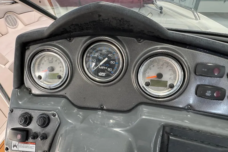 Slide: The Image of Dashboard of 2012 Yamaha Boats SX210 with speedometer and control switches. - 5