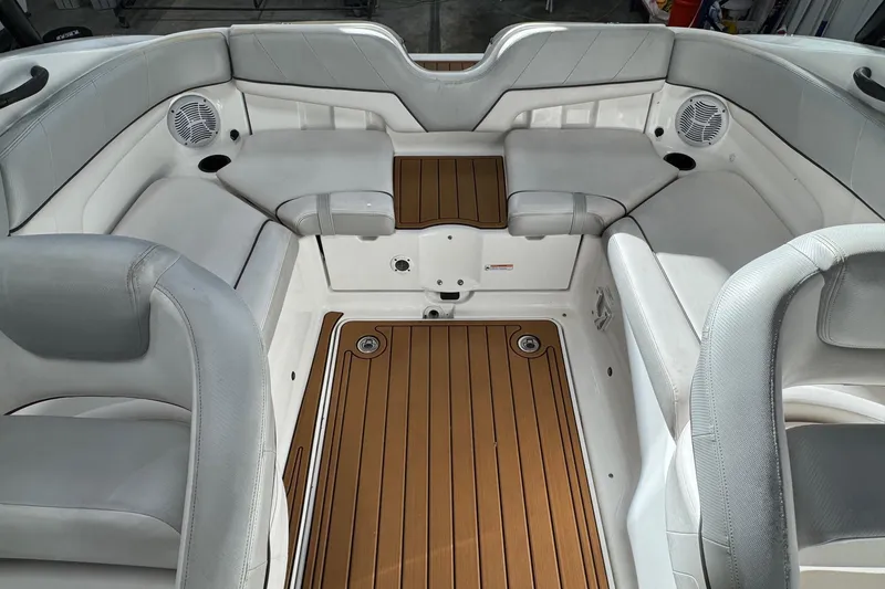 Slide: The Image of Interior of 2012 Yamaha SX210 boat with cushioned seating and teak-style flooring. - 7