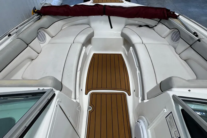 Slide: The Image of 2012 Yamaha Boats SX210 interior with cushioned seating and teak-style flooring. - 9