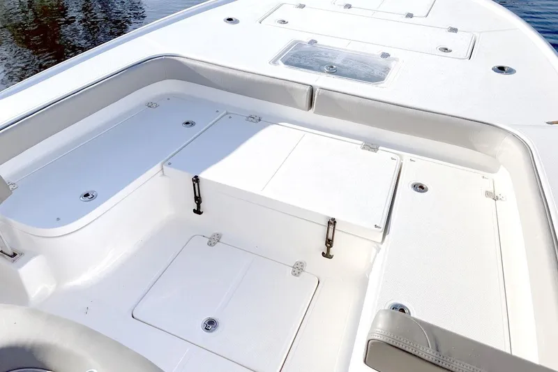 Slide: The Image of Manufacturer Provided Image: 2025 Sea Born FX25 Bay boat interior with storage compartments and seating. - 3