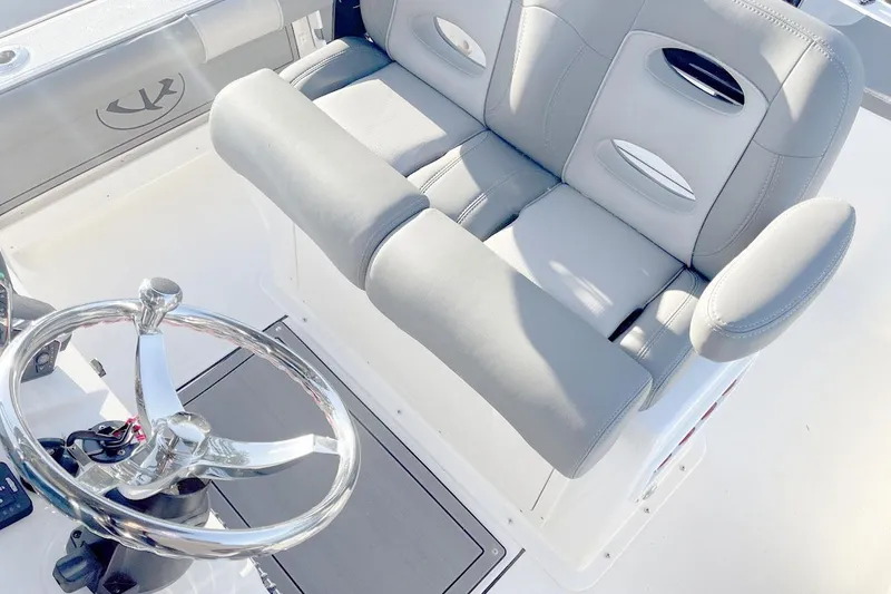 Slide: The Image of Manufacturer Provided Image: 2025 Sea Born FX25 Bay boat interior with steering wheel and cushioned seating. - 4