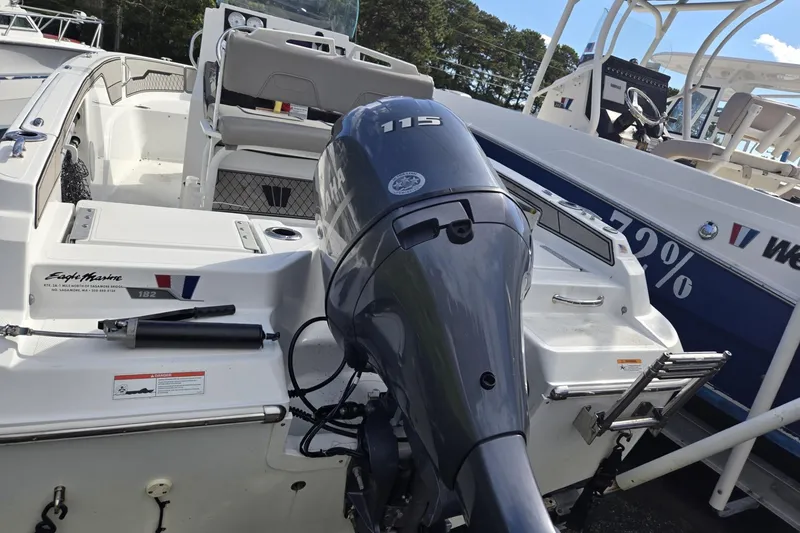 Slide: The Image of 2020 Wellcraft 202 Fisherman boat with Yamaha 115 outboard motor, docked outdoors. - 4