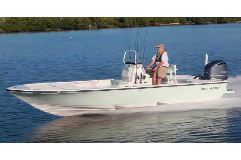 Slide: The Image of Manufacturer Provided Image: 2025 Sea Born FX24 Bay boat cruising on a calm lake with a person steering. - 2
