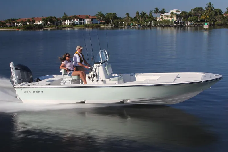 Slide: The Image of Manufacturer Provided Image: 2025 Sea Born FX24 Bay boat cruising on calm water with two passengers. - 1