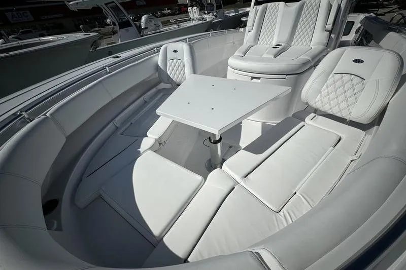 Slide: The Image of 2025 Sportsman Open 352 Center Console with luxurious white seating and table setup. - 12
