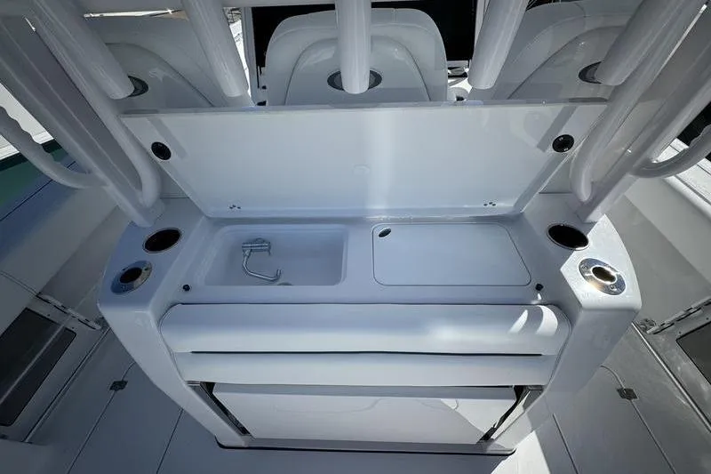Slide: The Image of 2025 Sportsman Open 352 Center Console boat interior with sink and storage compartments. - 23