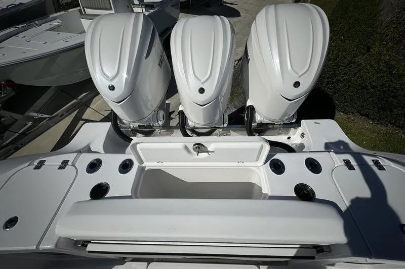 Slide: The Image of 2025 Sportsman Open 352 Center Console with triple outboard engines, rear view. - 28