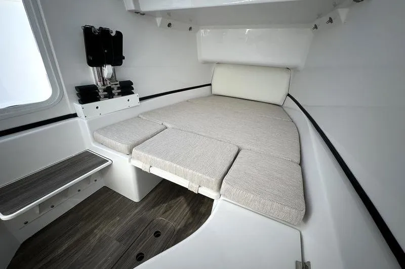 Slide: The Image of 2025 Sportsman Open 352 Center Console cabin interior with cushioned seating and wood flooring. - 35