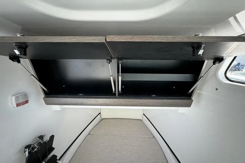 Slide: The Image of 2025 Sportsman Open 352 Center Console cabin interior with storage compartments. - 37