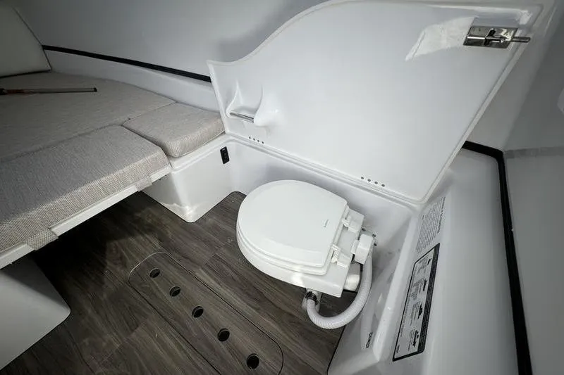 Slide: The Image of 2025 Sportsman Open 352 Center Console boat interior with toilet and seating area. - 41