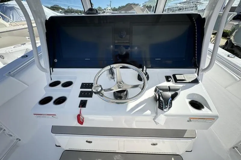 Slide: The Image of 2025 Sportsman Open 352 Center Console helm with steering wheel and controls. - 42