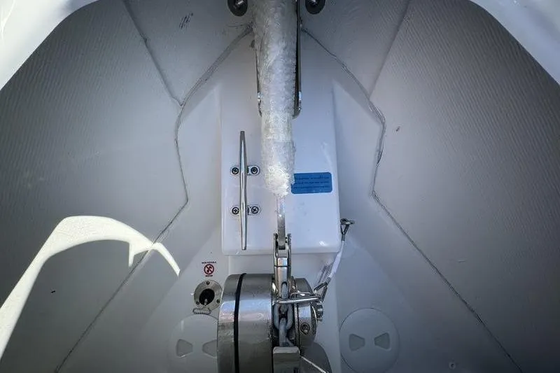 Slide: The Image of Anchor compartment of 2025 Sportsman Open 352 Center Console boat, featuring secure chain mechanism. - 8