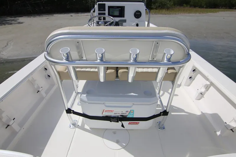Slide: The Image of Manufacturer Provided Image: 2025 Sea Born FX21 Bay boat interior with rod holders and cooler on deck. - 10