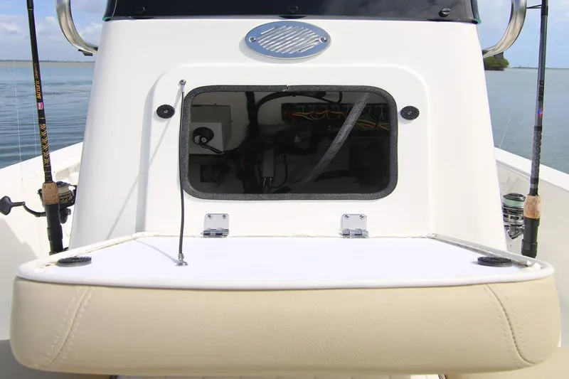 Slide: The Image of Manufacturer Provided Image: 2025 Sea Born FX21 Bay boat console with fishing rods and storage compartment. - 6