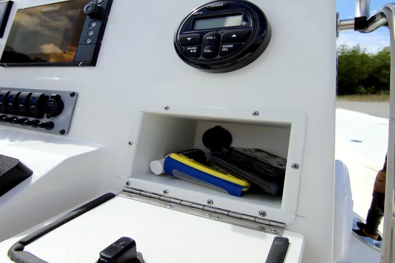 Slide: The Image of Manufacturer Provided Image: 2025 Sea Born FX21 Bay boat console with storage compartment and electronic controls. - 8