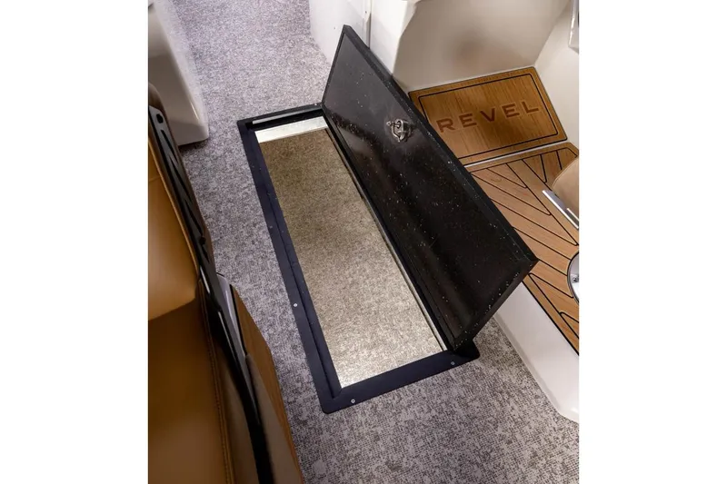 Slide: The Image of Manufacturer Provided Image: 2026 Revel RS25 boat interior with open storage compartment and carpeted flooring. - 12