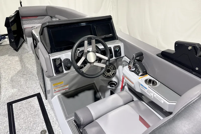 Slide: The Image of 2026 Revel RS25 boat interior with modern steering and control panel. - 2