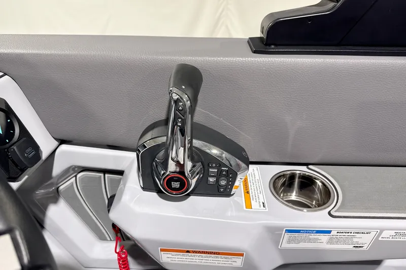 Slide: The Image of Control panel of 2026 Revel RS25 boat with throttle and cup holder. - 4