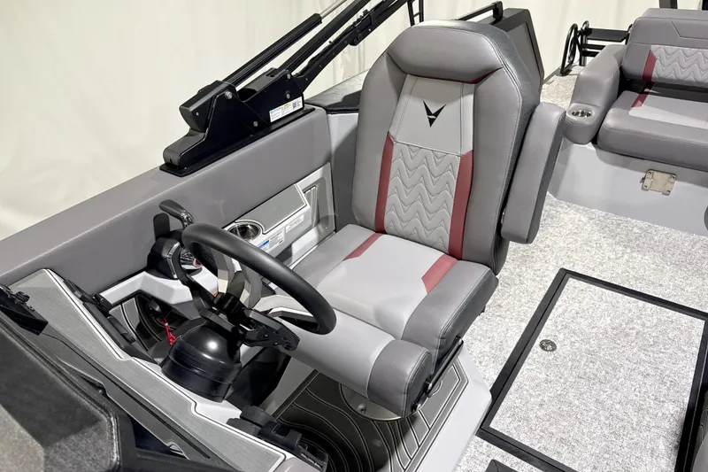 Slide: The Image of Captain's seat of 2026 Revel RS25 boat with modern steering and controls. - 5