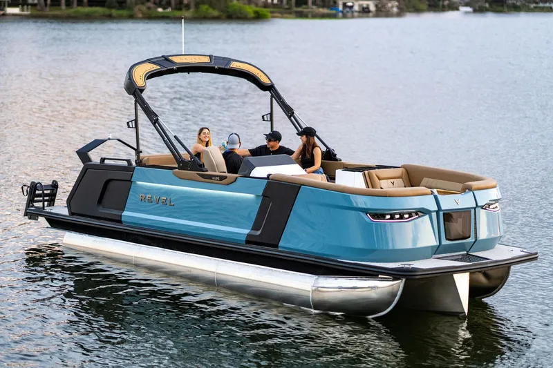 Slide: The Image of Manufacturer Provided Image: 2026 Revel RS25 pontoon boat on a lake with passengers enjoying the ride. - 9