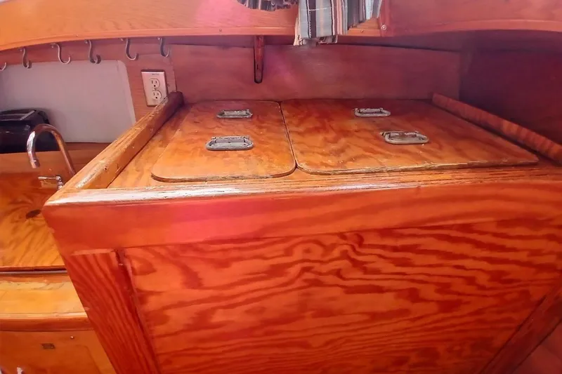Slide: The Image of 1976 Islander Freeport yacht interior with wooden cabinetry and sink. - 10