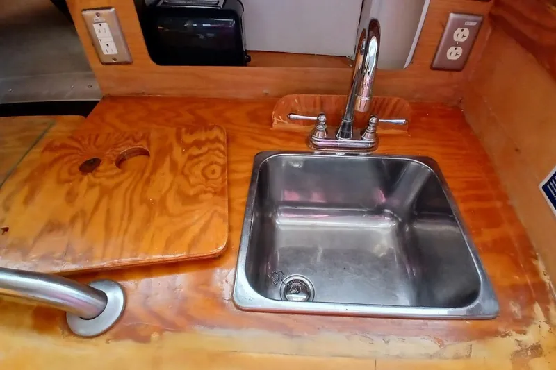 Slide: The Image of Wooden countertop with sink in 1976 Islander Freeport boat kitchen. - 12