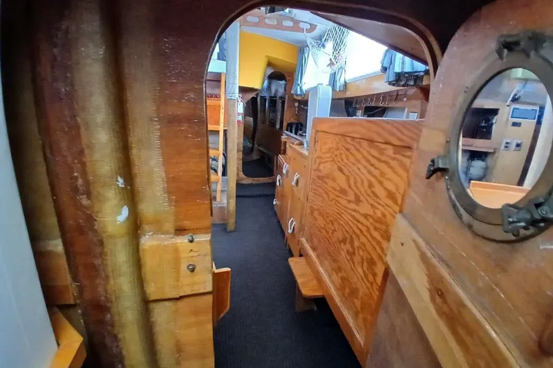 Slide: The Image of 1976 Islander Freeport yacht interior with wooden cabinetry and nautical decor. - 17