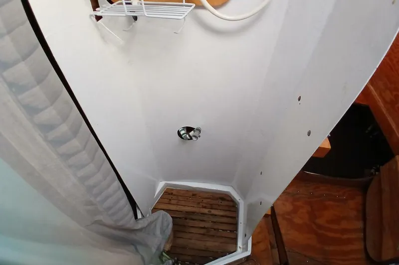 Slide: The Image of 1976 Islander Freeport boat shower with wooden floor and white walls. - 20