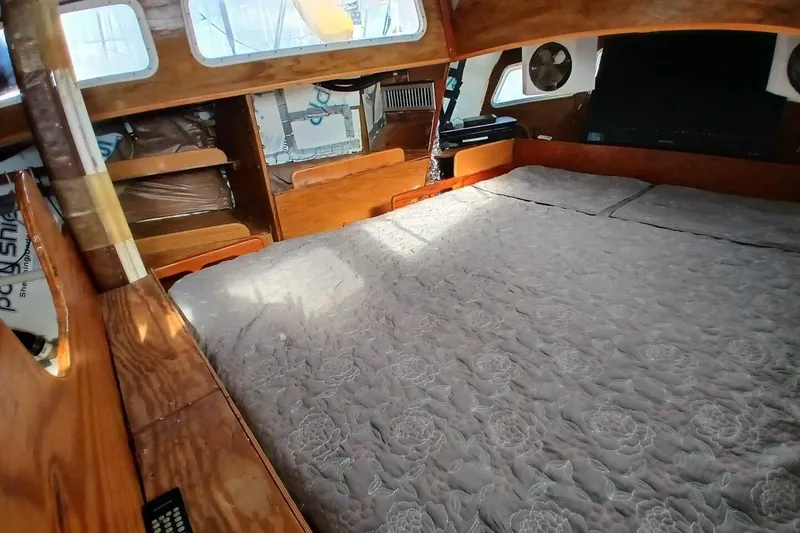 Slide: The Image of 1976 Islander Freeport yacht interior with cozy wooden cabin and bed. - 25