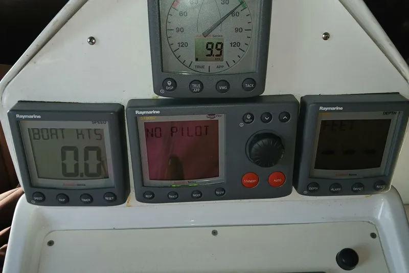 Slide: The Image of 1976 Islander Freeport boat dashboard with Raymarine instruments displaying speed and autopilot status. - 39