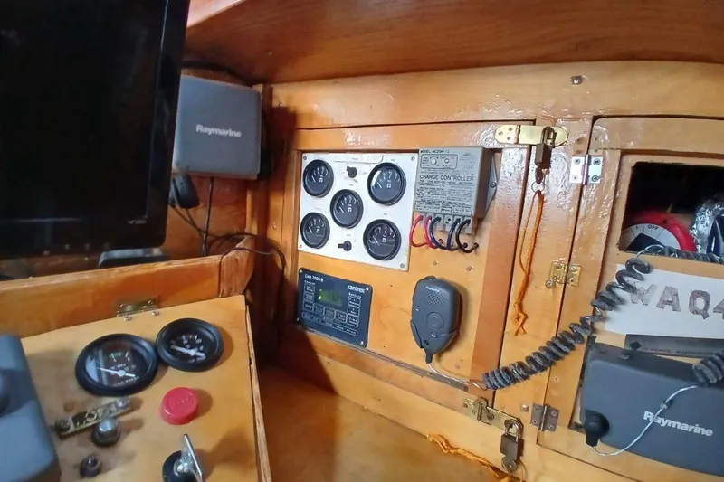 Slide: The Image of 1976 Islander Freeport boat interior with control panel and Raymarine equipment. - 42