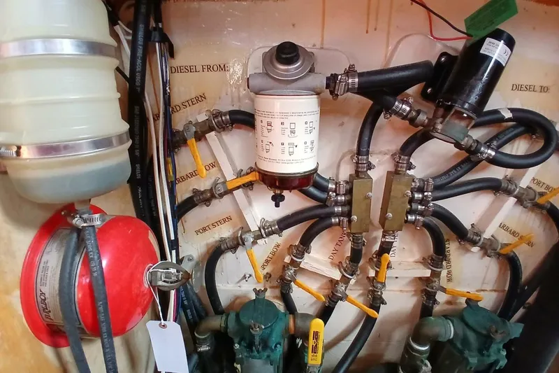 Slide: The Image of Engine room of 1976 Islander Freeport sailboat with fuel lines and filters. - 44
