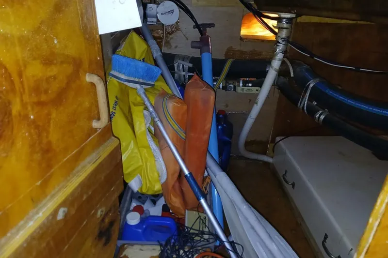 Slide: The Image of 1976 Islander Freeport boat interior with storage items and equipment. - 45