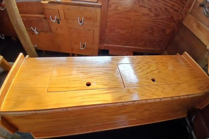 Slide: The Image of 1976 Islander Freeport interior with polished wooden cabinetry and storage compartments. - 6