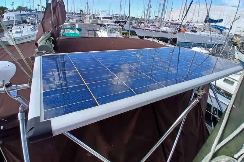 Slide: The Image of Solar panel on 1976 Islander Freeport sailboat in marina setting. - 60