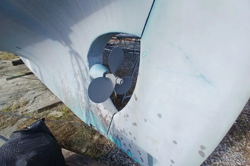 Slide: The Image of 1976 Islander Freeport sailboat propeller and hull on dry land. - 64